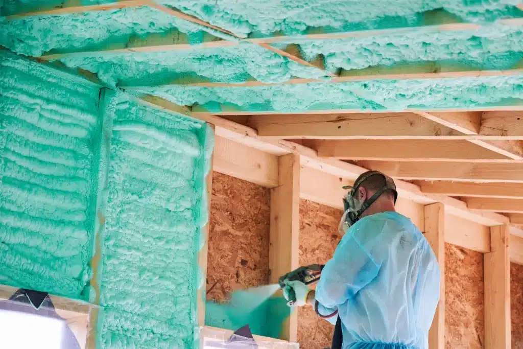 Certified installer applying closed-cell spray foam insulation in attic Certified installer applying closed-cell spray foam insulation in attic